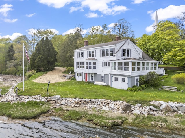 15 Church Ln, Phippsburg, ME 04562 - back of house featuring a sunroom, a chimney, a water view, and a lawn