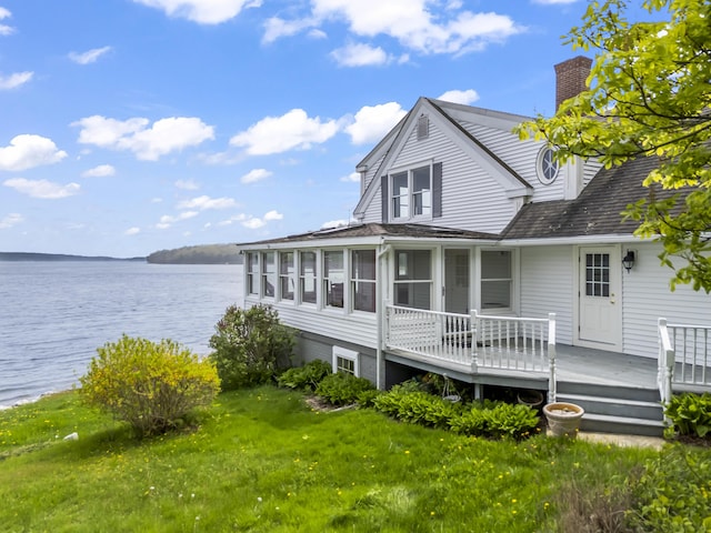 15 Church Ln, Phippsburg, ME 04562 - rear view of house featuring a chimney, a sunroom, a yard, and a deck with water view