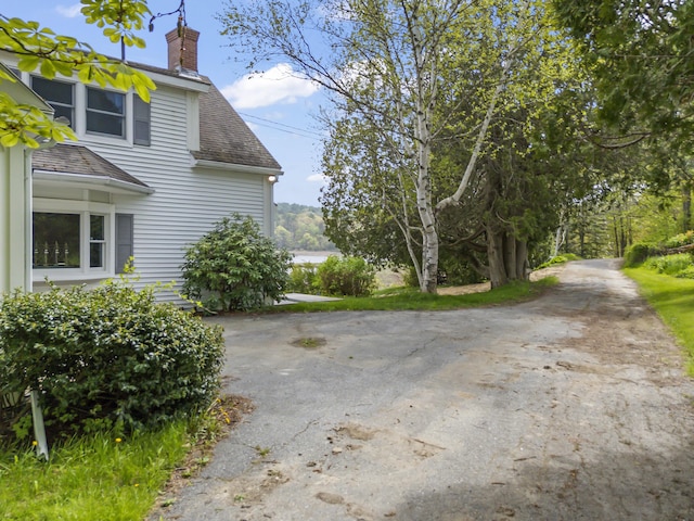 15 Church Ln, Phippsburg, ME 04562 - view of side of property with a shingled roof and a chimney