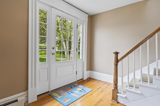 15 Church Ln, Phippsburg, ME 04562 - entrance foyer featuring light wood-style floors, stairway, and a baseboard radiator
