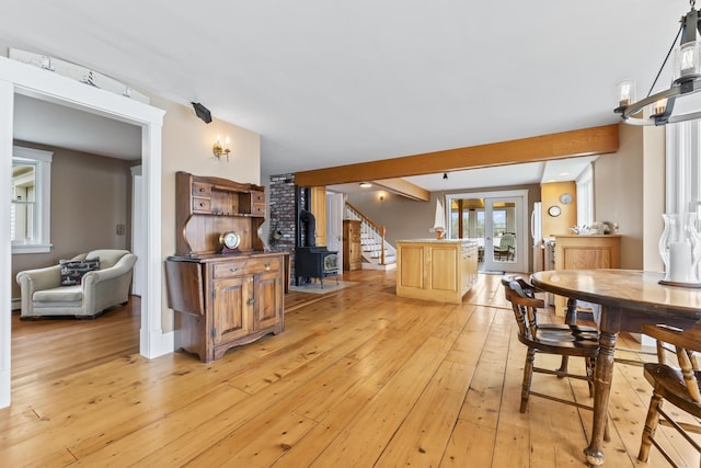 15 Church Ln, Phippsburg, ME 04562 - dining room with light wood finished floors, stairway, french doors, and a wood stove