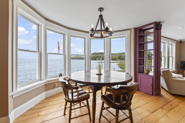 15 Church Ln, Phippsburg, ME 04562 - dining room featuring a chandelier, light wood-type flooring, healthy amount of natural light, and baseboards