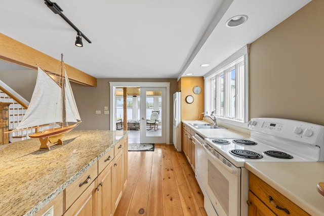 15 Church Ln, Phippsburg, ME 04562 - kitchen with white appliances, french doors, a sink, light wood-style floors, and recessed lighting