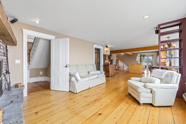 15 Church Ln, Phippsburg, ME 04562 - living area featuring stairway, hardwood / wood-style flooring, a large fireplace, recessed lighting, and french doors