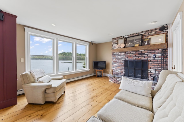 15 Church Ln, Phippsburg, ME 04562 - living room featuring a baseboard heating unit, light wood-type flooring, and a fireplace