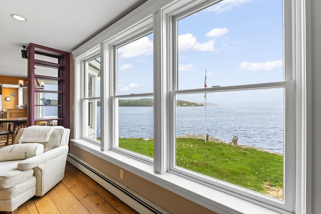 15 Church Ln, Phippsburg, ME 04562 - sunroom / solarium featuring a water view, wood-type flooring, baseboard heating, and recessed lighting