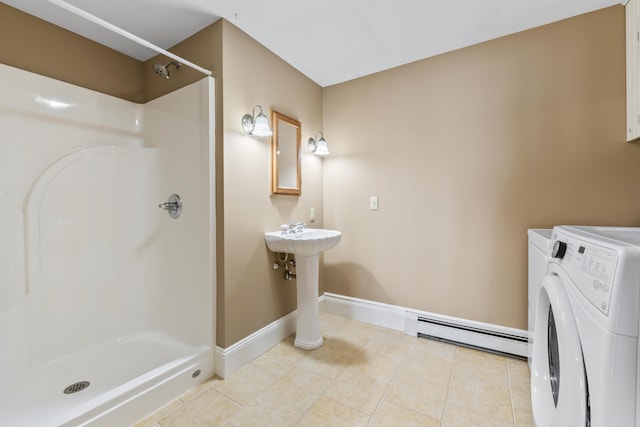 15 Church Ln, Phippsburg, ME 04562 - bathroom with baseboard heating, washing machine and clothes dryer, a stall shower, and tile patterned flooring