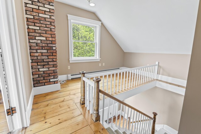 15 Church Ln, Phippsburg, ME 04562 - staircase featuring wood-type flooring, lofted ceiling, a baseboard radiator, and baseboards