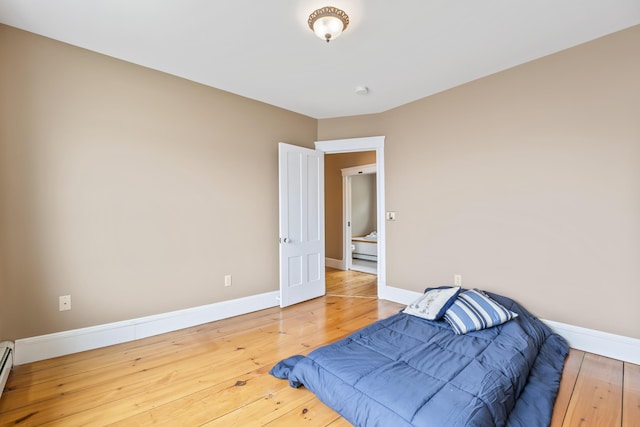 15 Church Ln, Phippsburg, ME 04562 - bedroom with baseboards, wood finished floors, and a baseboard heating unit