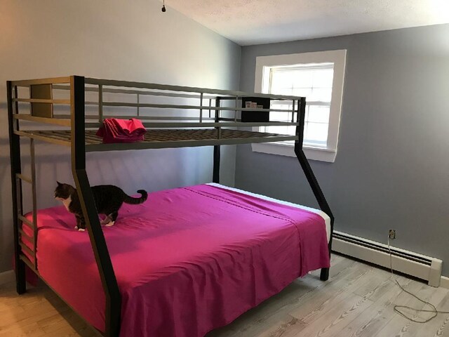 450 W Rd, Waterboro, ME 04087 - bedroom featuring a baseboard heating unit, wood finished floors, and baseboards