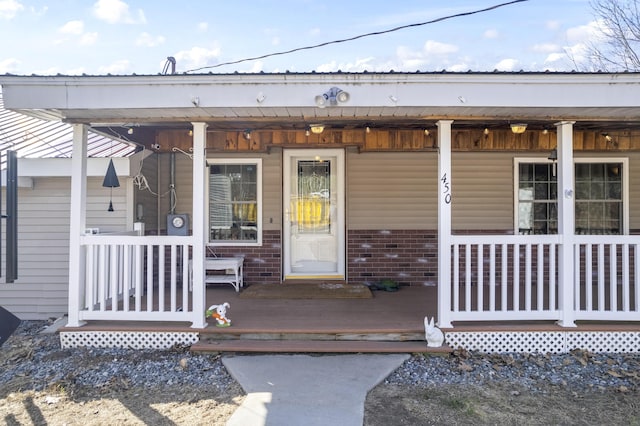450 W Rd, Waterboro, ME 04087 - doorway to property featuring covered porch and brick siding