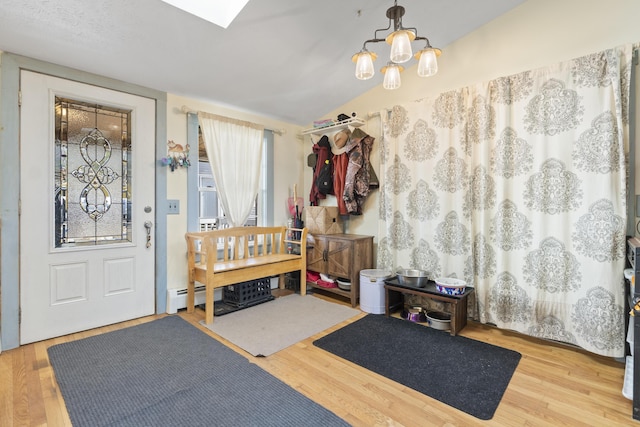 450 W Rd, Waterboro, ME 04087 - foyer with wood finished floors, a baseboard heating unit, and a chandelier