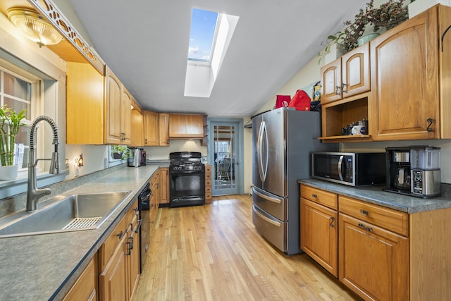 450 W Rd, Waterboro, ME 04087 - kitchen with black appliances, a skylight, a sink, light wood-type flooring, and open shelves
