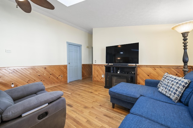 450 W Rd, Waterboro, ME 04087 - living area featuring a wainscoted wall, wood walls, light wood finished floors, and a ceiling fan
