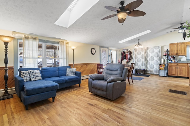 450 W Rd, Waterboro, ME 04087 - living area with a skylight, ceiling fan, a textured ceiling, wainscoting, and vaulted ceiling