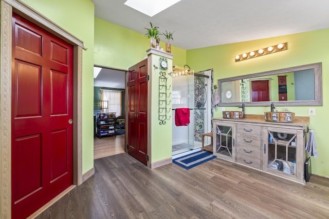 450 W Rd, Waterboro, ME 04087 - full bath featuring wood finished floors, a skylight, a stall shower, vanity, and baseboards