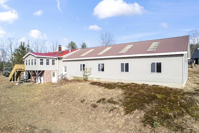 450 W Rd, Waterboro, ME 04087 - back of property with stairs, metal roof, and a deck