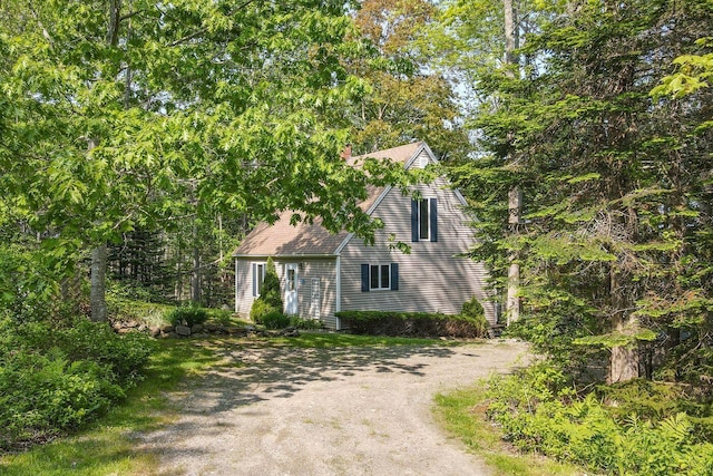 15 Eds Rd, Camden, ME 04843 - view of front of property featuring dirt driveway, roof with shingles, and a chimney