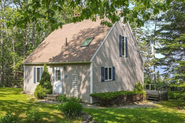 15 Eds Rd, Camden, ME 04843 - back of property with a lawn, a shingled roof, and a wooden deck