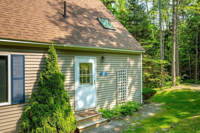 15 Eds Rd, Camden, ME 04843 - view of property exterior featuring roof with shingles, entry steps, and a yard