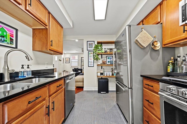 81 Forest Ave, Portland, ME 04101 - kitchen with appliances with stainless steel finishes, dark countertops, brown cabinetry, and a ceiling fan