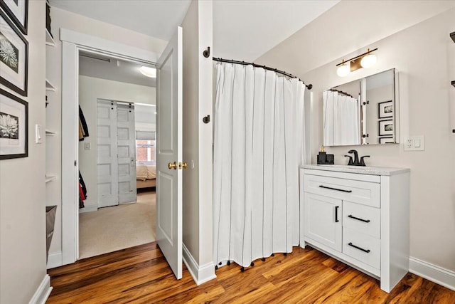 81 Forest Ave, Portland, ME 04101 - ensuite bathroom with vanity, wood finished floors, and a shower with curtain