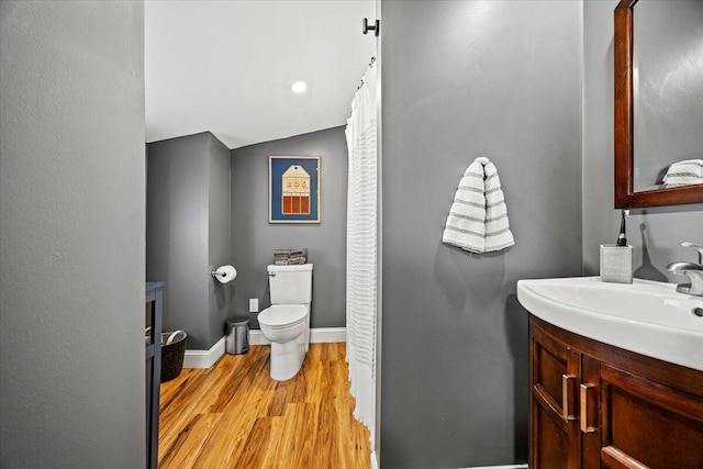 81 Forest Ave, Portland, ME 04101 - bathroom with vanity, wood finished floors, and lofted ceiling