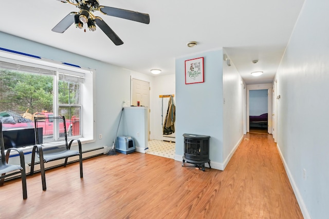 interior space with baseboards, light wood-style flooring, and a ceiling fan