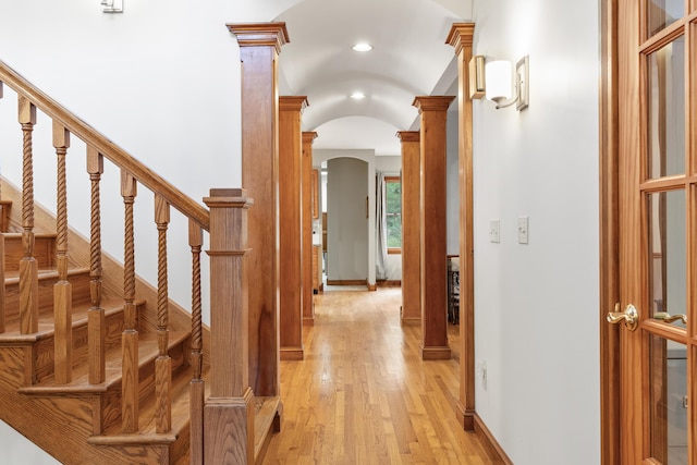 39 Catlin Shore Rd, Harpswell, ME 04079 - hall featuring arched walkways, decorative columns, light wood finished floors, vaulted ceiling, and baseboards