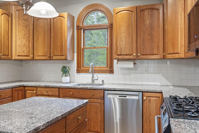 39 Catlin Shore Rd, Harpswell, ME 04079 - kitchen featuring appliances with stainless steel finishes, a sink, brown cabinets, and tasteful backsplash