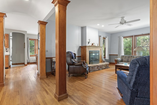 39 Catlin Shore Rd, Harpswell, ME 04079 - living room featuring ornate columns, arched walkways, a ceiling fan, a fireplace, and healthy amount of natural light