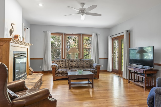 39 Catlin Shore Rd, Harpswell, ME 04079 - living room with healthy amount of natural light, a glass covered fireplace, a ceiling fan, light wood-type flooring, and recessed lighting