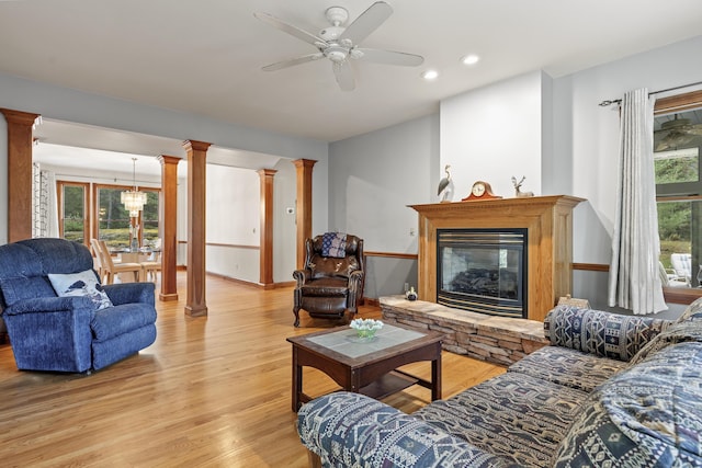 39 Catlin Shore Rd, Harpswell, ME 04079 - living area with decorative columns, light wood-style floors, a fireplace, recessed lighting, and a ceiling fan