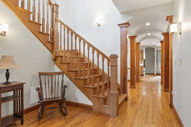 39 Catlin Shore Rd, Harpswell, ME 04079 - stairway featuring arched walkways, decorative columns, hardwood / wood-style floors, baseboards, and recessed lighting