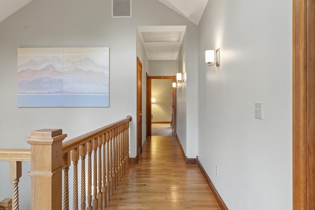 39 Catlin Shore Rd, Harpswell, ME 04079 - hall featuring light wood-style floors, vaulted ceiling, attic access, and an upstairs landing
