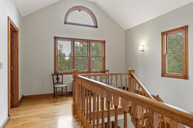 39 Catlin Shore Rd, Harpswell, ME 04079 - hallway with an upstairs landing, light wood-type flooring, plenty of natural light, vaulted ceiling, and baseboards