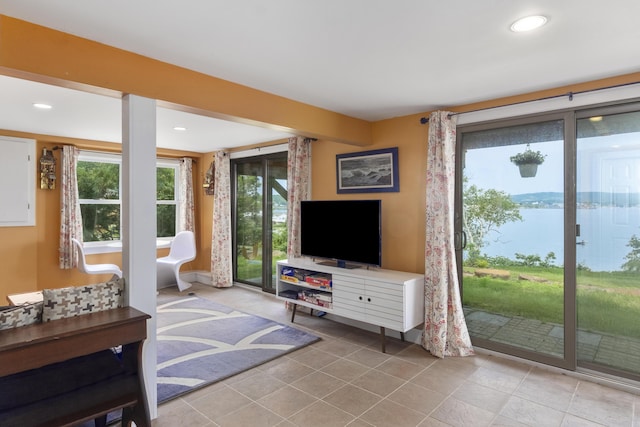 living area featuring recessed lighting, baseboards, tile patterned floors, and a wealth of natural light
