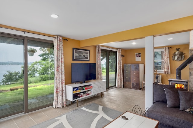 living area with a wood stove and recessed lighting