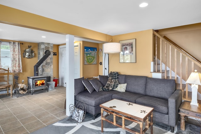 tiled living room featuring recessed lighting, a wood stove, and stairway