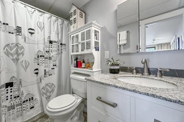 full bathroom featuring a shower with curtain, vanity, a drop ceiling, and toilet