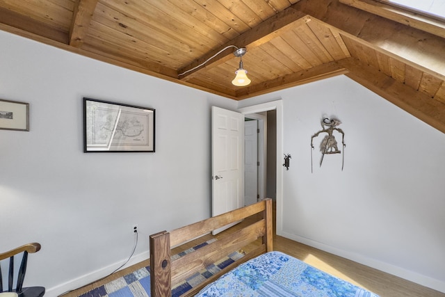 bedroom with baseboards, beam ceiling, wood finished floors, and wooden ceiling