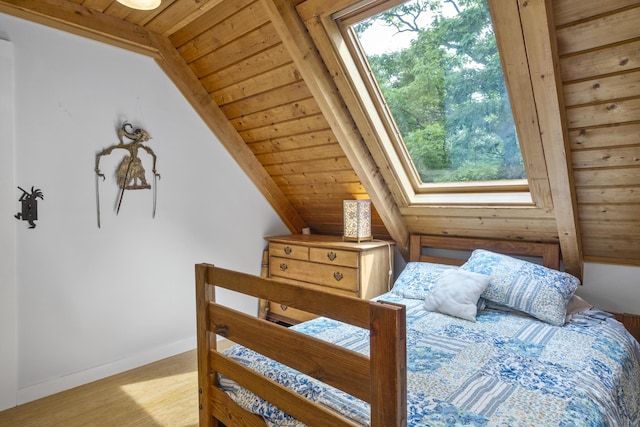 bedroom with baseboards, light wood finished floors, vaulted ceiling, and wooden ceiling
