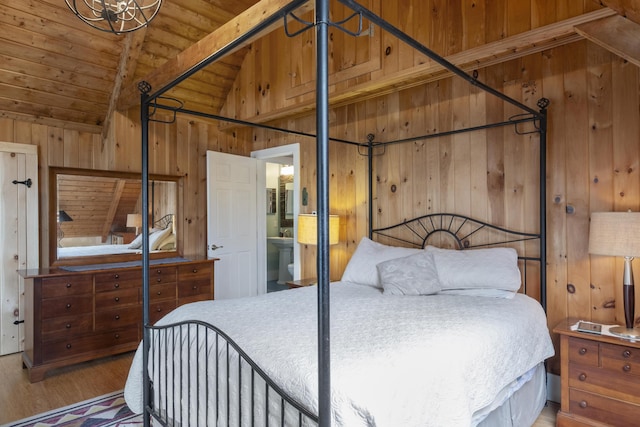 bedroom with wood walls, wooden ceiling, wood finished floors, and lofted ceiling