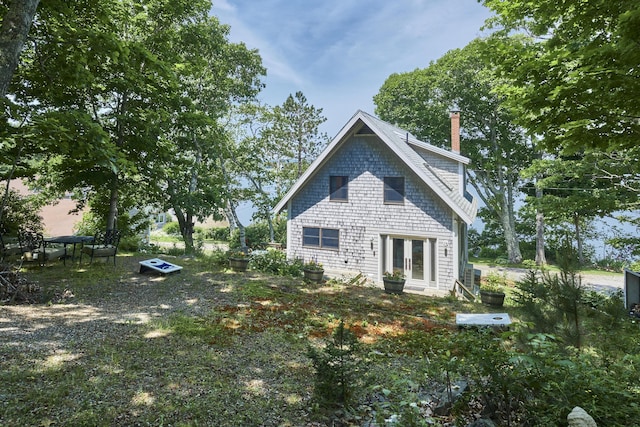 exterior space featuring french doors and a chimney