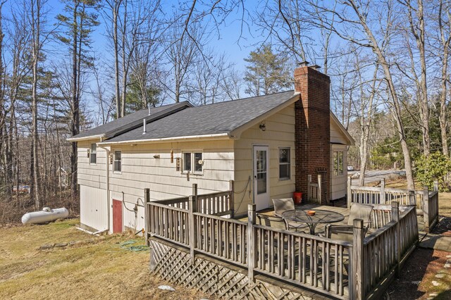 369 Windham Center Rd, Windham, ME 04062 - back of property featuring a chimney, a wooden deck, and roof with shingles