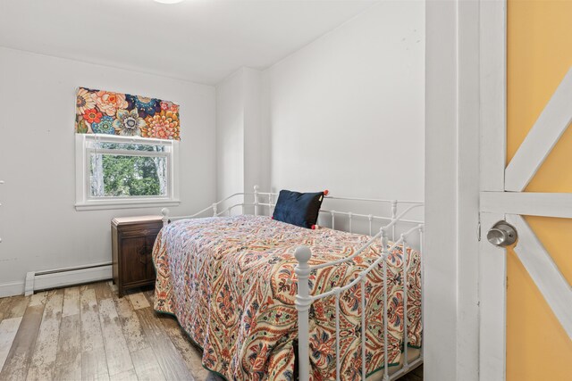 369 Windham Center Rd, Windham, ME 04062 - bedroom with wood finished floors and a baseboard heating unit