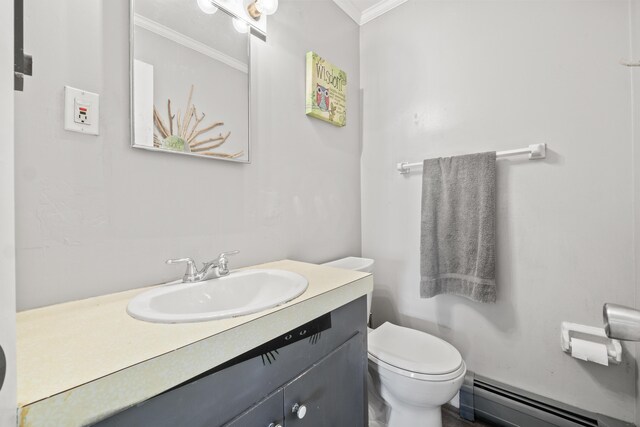 369 Windham Center Rd, Windham, ME 04062 - bathroom featuring vanity, ornamental molding, toilet, and baseboard heating