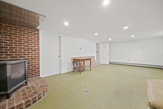 369 Windham Center Rd, Windham, ME 04062 - finished basement featuring a baseboard heating unit, recessed lighting, and a wood stove