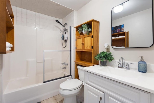 bathroom featuring toilet, bathtub / shower combination, vanity, and tile patterned floors
