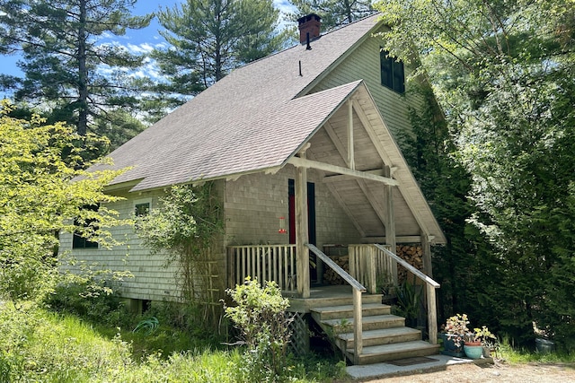 67 Rob Rd, Brooklin, ME 04616 - view of side of home featuring a shingled roof and a chimney